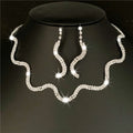 Silver jewelry set with necklace and earrings on a black stand