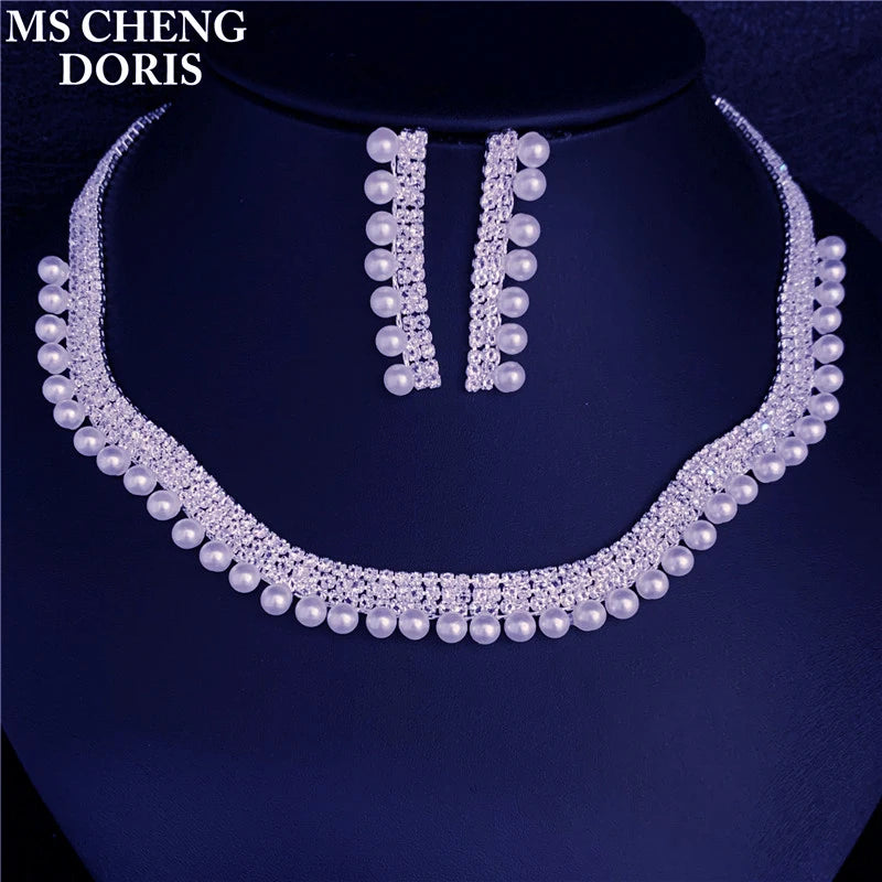 Pearl necklace and earrings set on a dark background with 'MS CHENG DORIS' branding.