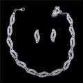 Silver necklace and earrings on a black background