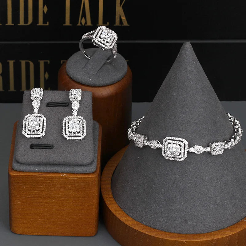 Jewelry set including necklace, bracelet, and earrings on a green mannequin bust.