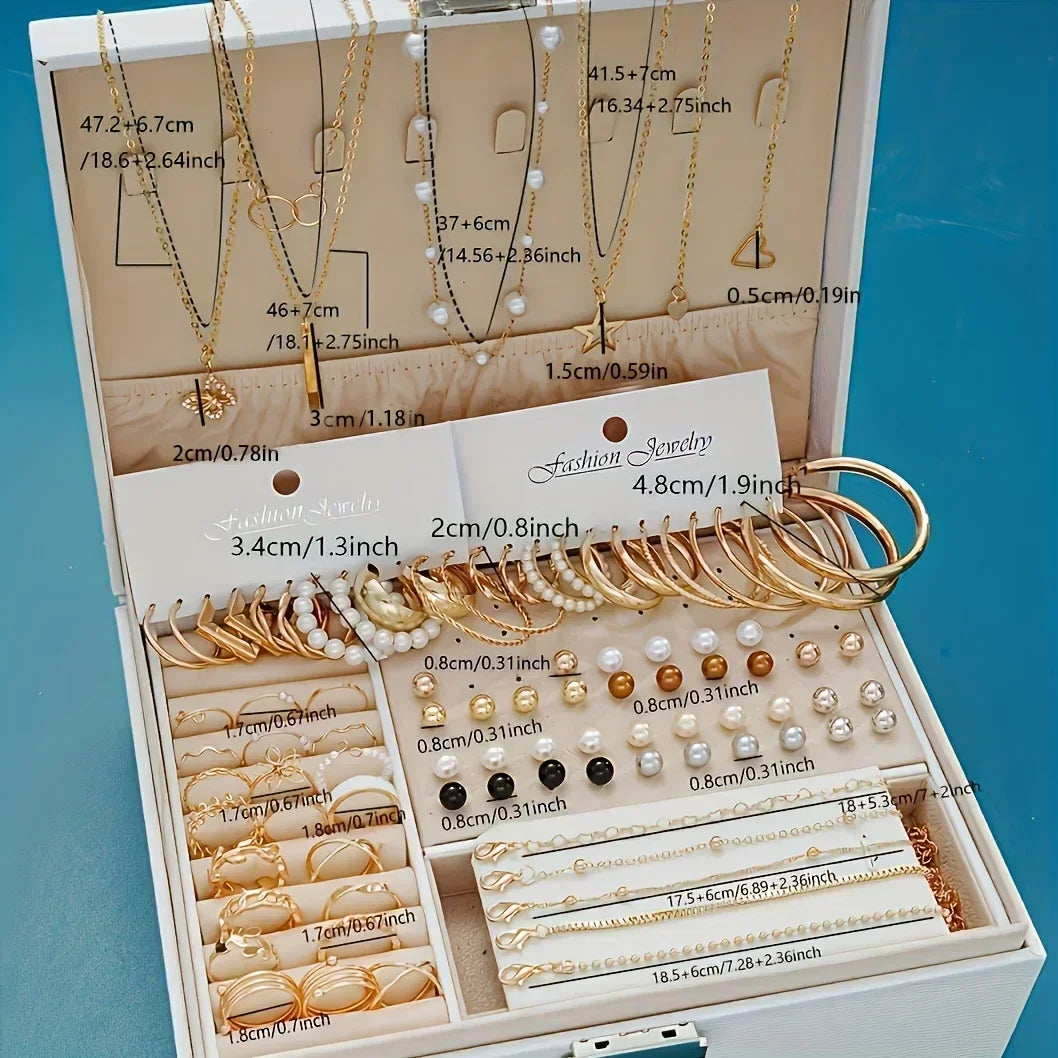 Jewelry set with necklaces, bracelets, and earrings in a display box on a blue background.