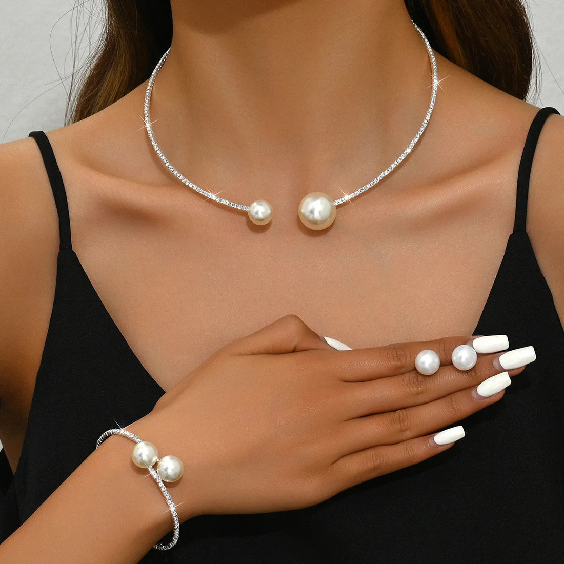 Pearl necklace and bracelet on a model against a neutral background