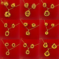 Gold jewelry set with necklace and earrings on a red background