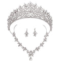 Silver tiara, necklace, and earrings set on a white background