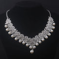 Pearl and crystal necklace on a black background