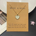 Heart-shaped necklace on a 'Make a Wish' card with a star-shaped object in the background