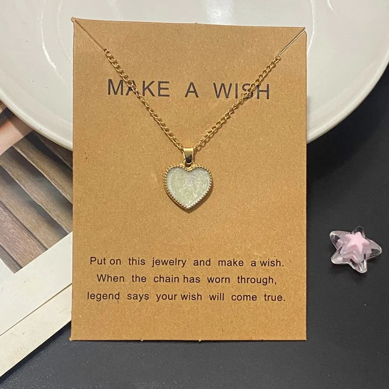 Heart-shaped necklace on a 'Make a Wish' card with a star-shaped object in the background