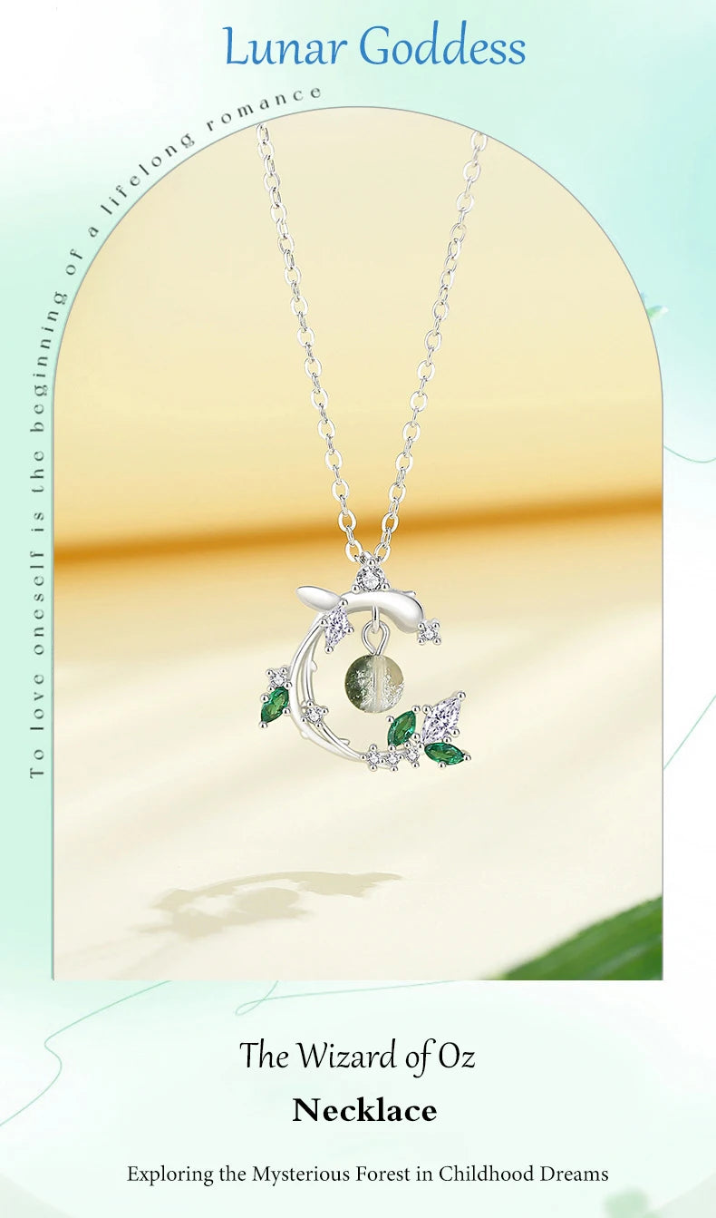 Silver necklace with a moon pendant and green stones on a beige background