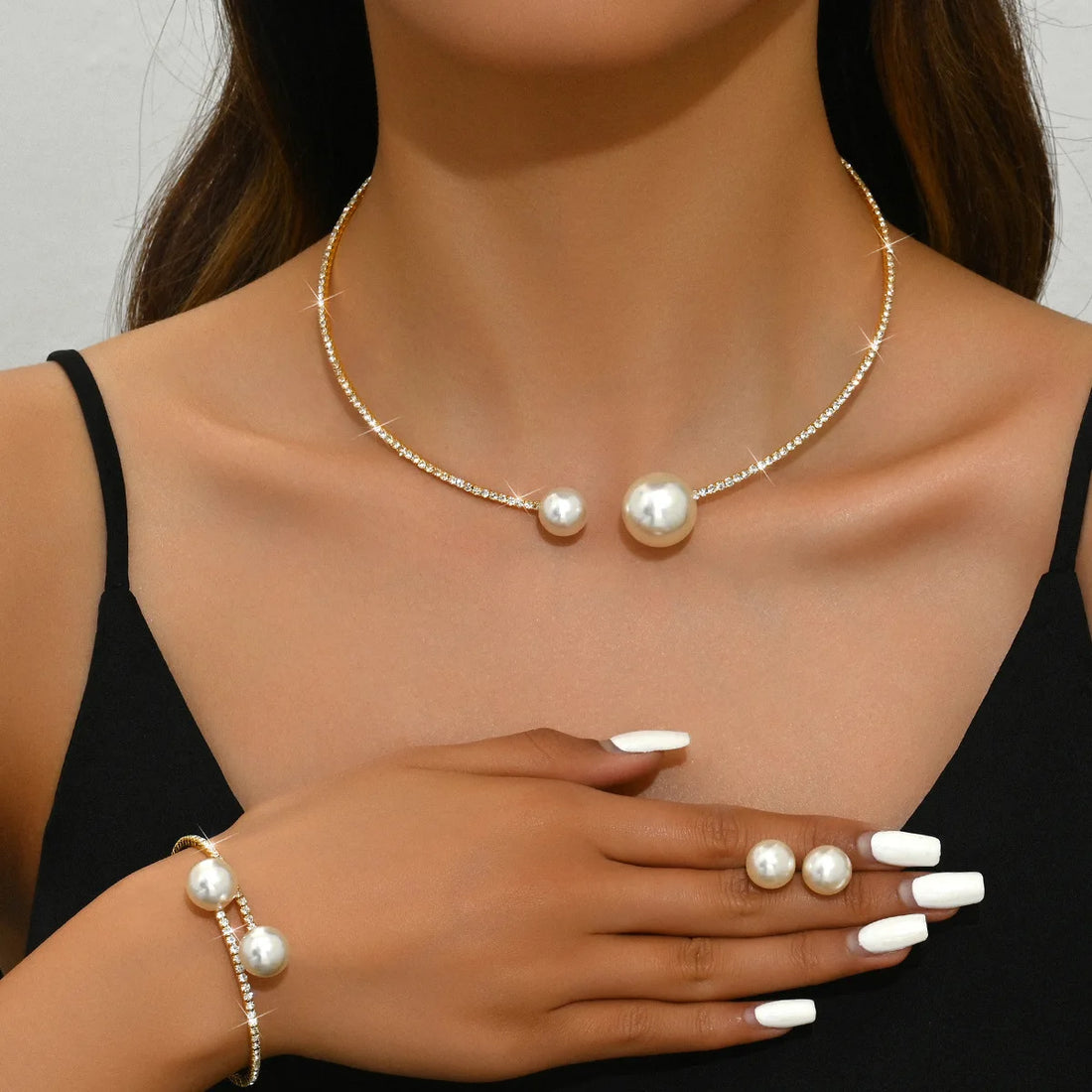 Pearl necklace and bracelet on a model against a neutral background