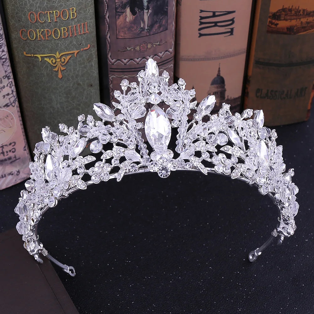 Jewelry set with tiara, necklace, and earrings on a pink display box.