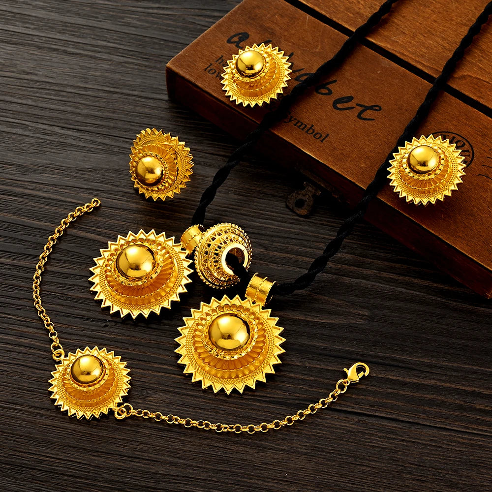 Gold jewelry set with necklace and earrings on a wooden surface
