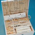 Jewelry set with necklaces, bracelets, and earrings in an open display case on a blue background.