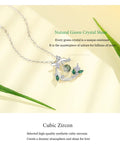Silver necklace with green crystal pendant on a beige background