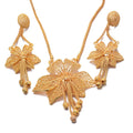 Gold necklace with floral designs on a white background