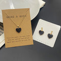 Heart-shaped jewelry set with necklace and earrings on display cards.
