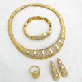 Gold jewelry set with necklace, bracelet, ring, and earrings on a white background