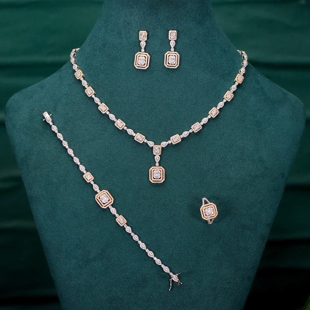 Jewelry set with necklace, bracelet, and earrings on a green stand.