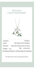 Necklace with green crystal pendant on a white card with text details.