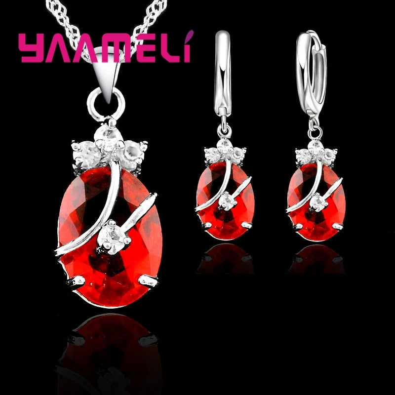 Jewelry set with purple gemstones and silver accents on a black background, featuring the brand 'YAAMELI'.