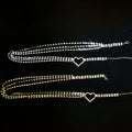 Two heart-shaped anklets on a black background