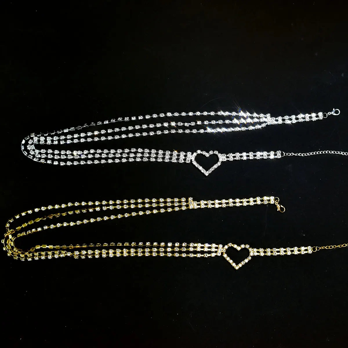 Two heart-shaped anklets on a black background