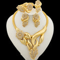 Gold necklace and earrings set on a white stand with a black background