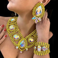 Close-up of a person wearing a yellow gemstone necklace, earrings, and bracelet.