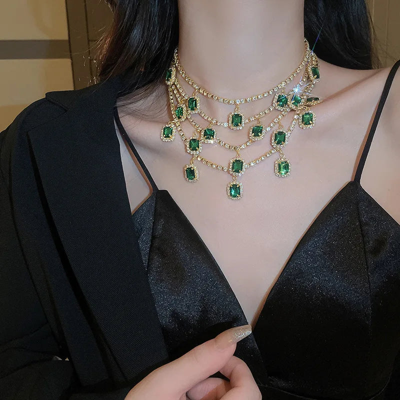 Woman wearing a luxurious emerald green necklace with a blurred background
