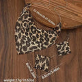 Leopard print jewelry set including necklace, bracelet, and earrings on a wooden surface with measurements.