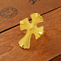 Gold cross ring on a wooden surface