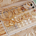 Assorted gold and pearl earrings in a jewelry box