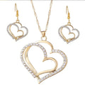 Gold heart-shaped jewelry set with necklace and earrings on a white background