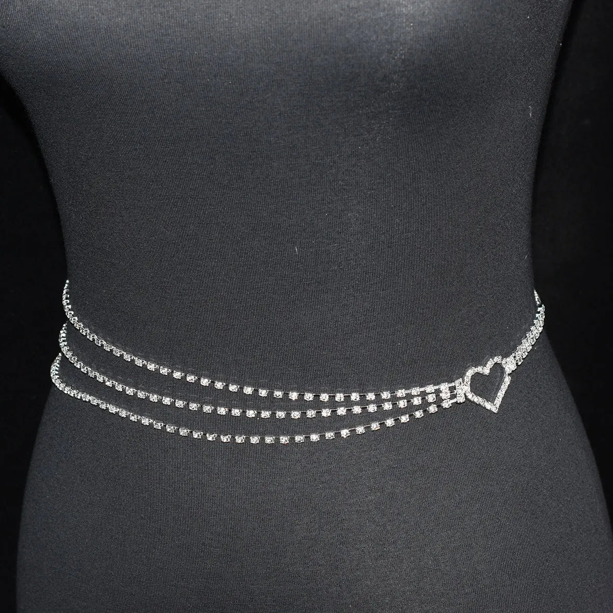 Silver chain belt with heart clasp on a black mannequin