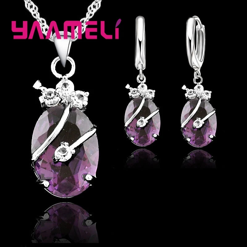 Jewelry set with purple gemstones and silver accents on a black background, featuring the brand 'YAAMELI'.