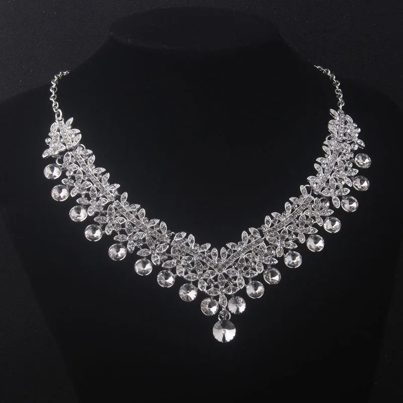 Silver necklace with clear crystals on a black background