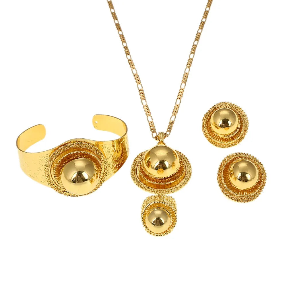 Gold jewelry set including necklace, earrings, and bracelet on a red surface.