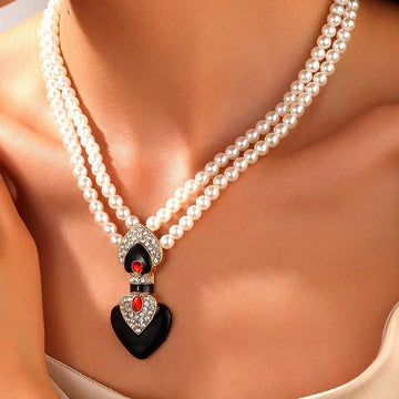 Pearl necklace with a heart-shaped pendant worn by a person