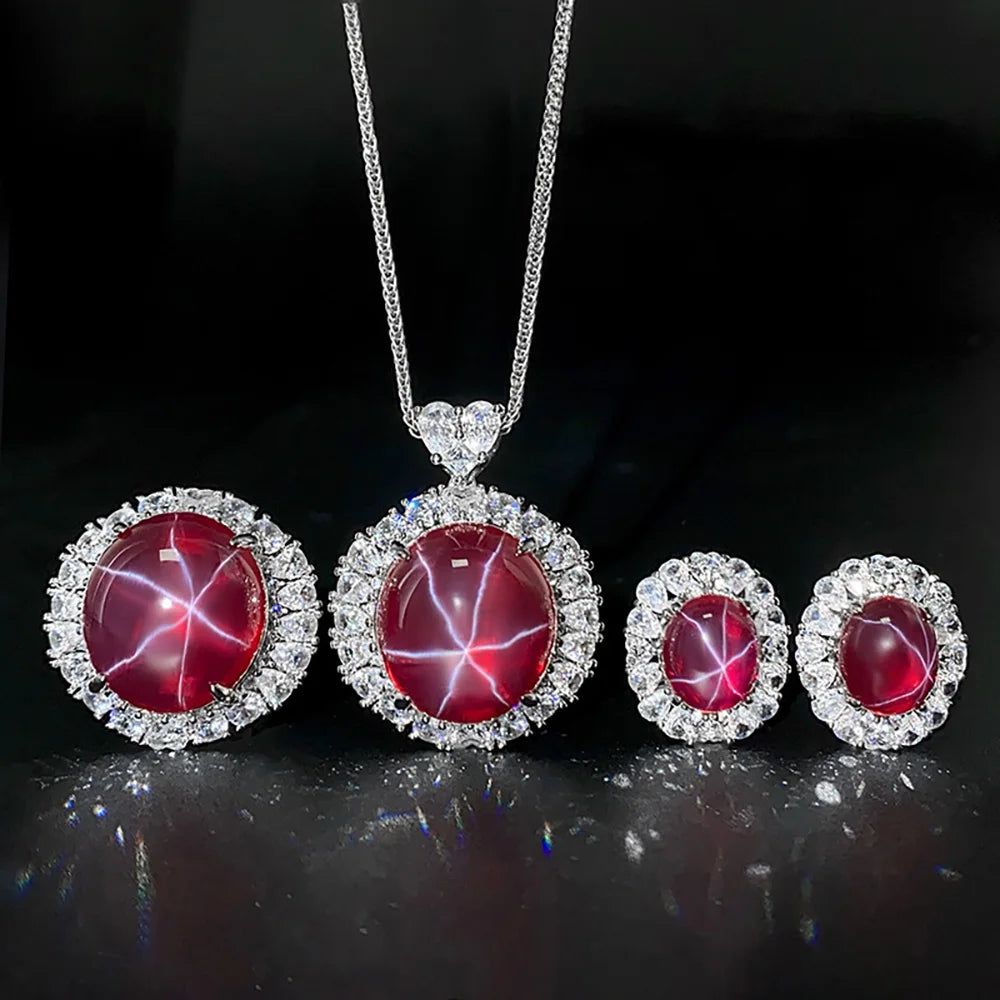 Jewelry set with red gemstones and silver settings on a dark background